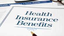 health insurance benefits form with pen and calculator