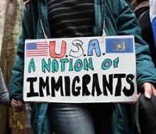 Sign reading "USA: A Nation of Immigrants"